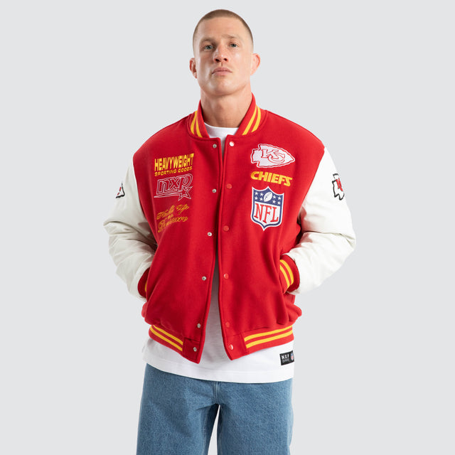 Model Wears Kansas City Chiefs Huddle Varsity Jacket Red/White Jackets in Red - Image 1