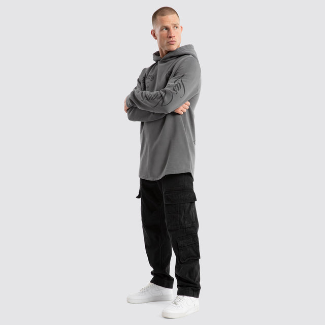 Model Wears Las Vegas Raiders Defence Dual Curved Hoodie Pigment Charcoal Hoodies in Grey - Image 2