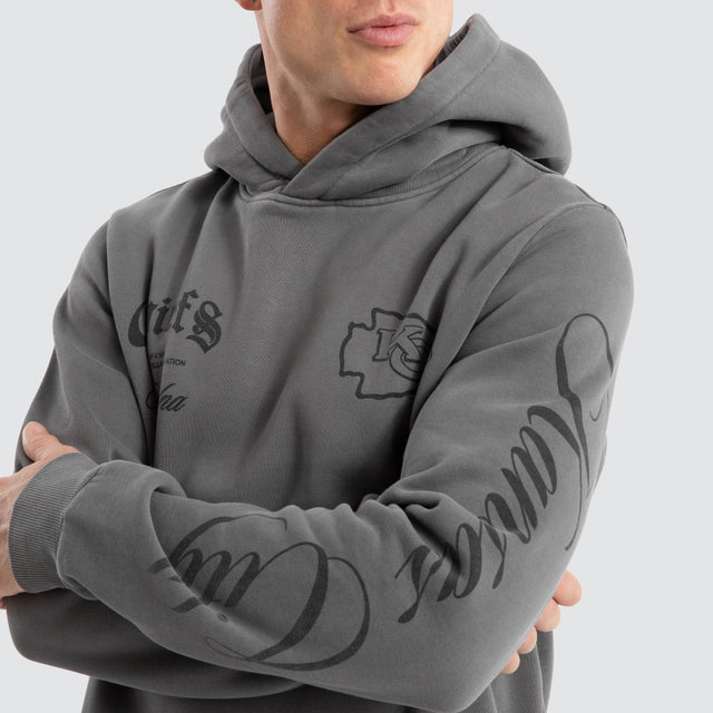 Model Wears Kansas City Chiefs Defence Dual Curved Hoodie Pigment Charcoal Hoodies in Grey - Image 6