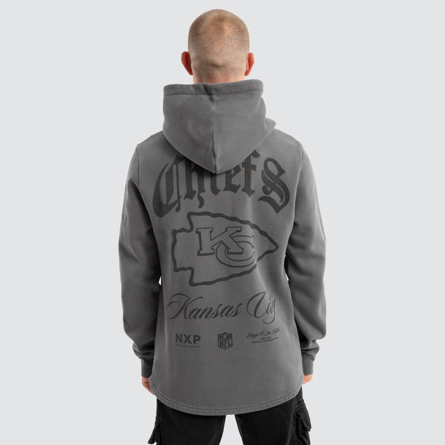 Model Wears Kansas City Chiefs Defence Dual Curved Hoodie Pigment Charcoal Hoodies in Grey - Image 1