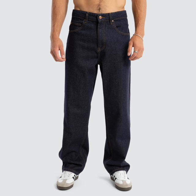 Model Wears Dillon Baggy Fit Jean Raw Denim Blue Pants in Blue - Image 6