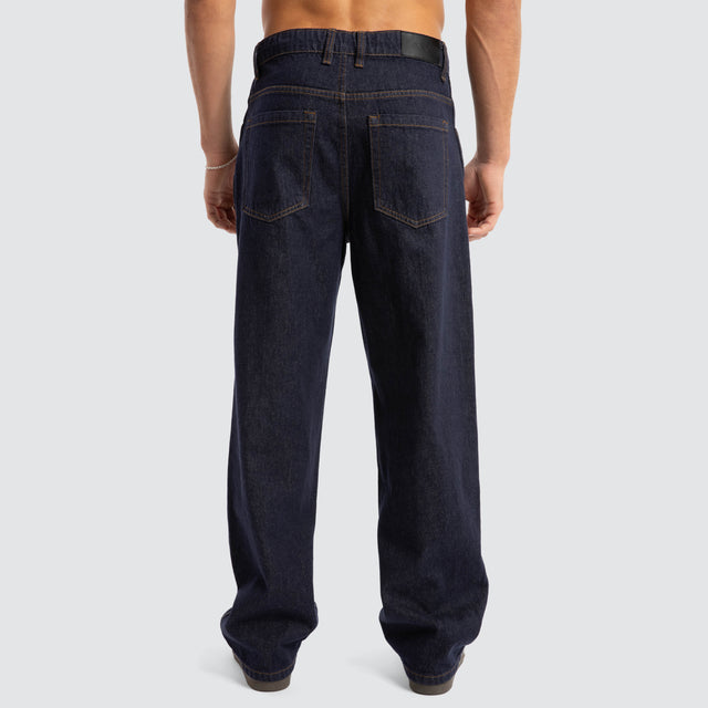 Model Wears Dillon Baggy Fit Jean Raw Denim Blue Pants in Blue - Image 5