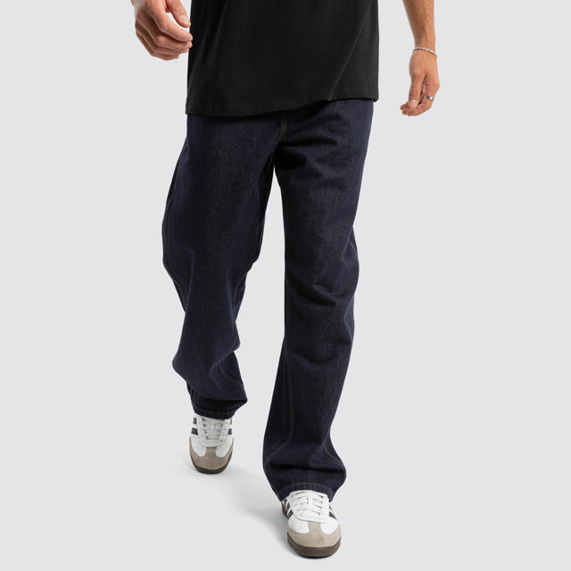 Model Wears Dillon Baggy Fit Jean Raw Denim Blue Pants in Blue - Image 7