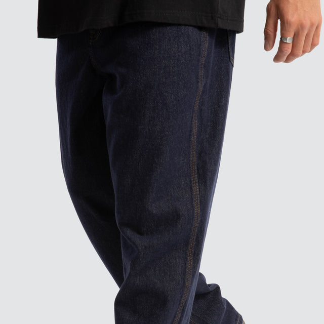 Model Wears Dillon Baggy Fit Jean Raw Denim Blue Pants in Blue - Image 4