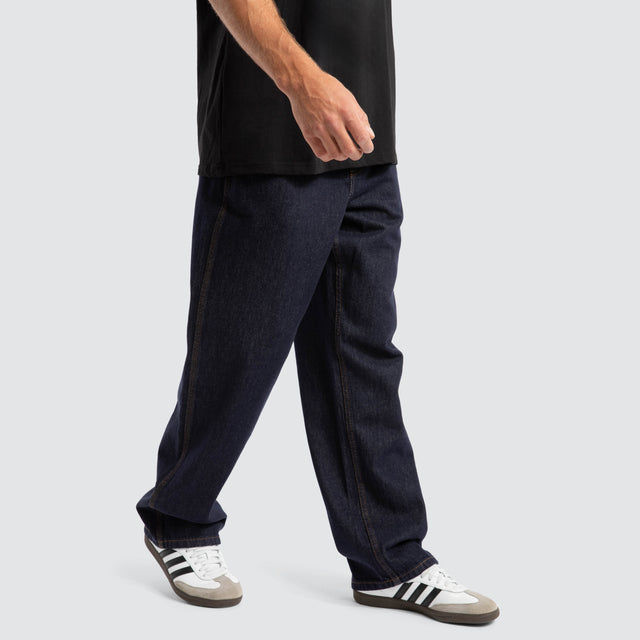 Model Wears Dillon Baggy Fit Jean Raw Denim Blue Pants in Blue - Image 3