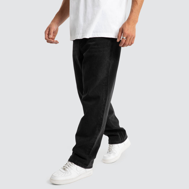 Model Wears Drive Athletic Baggy Jean Black Pants in Black - Image 3