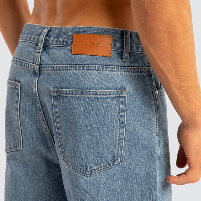 Model Wears Drive Athletic Baggy Jean Washed Blue Pants in Blue - Image 4