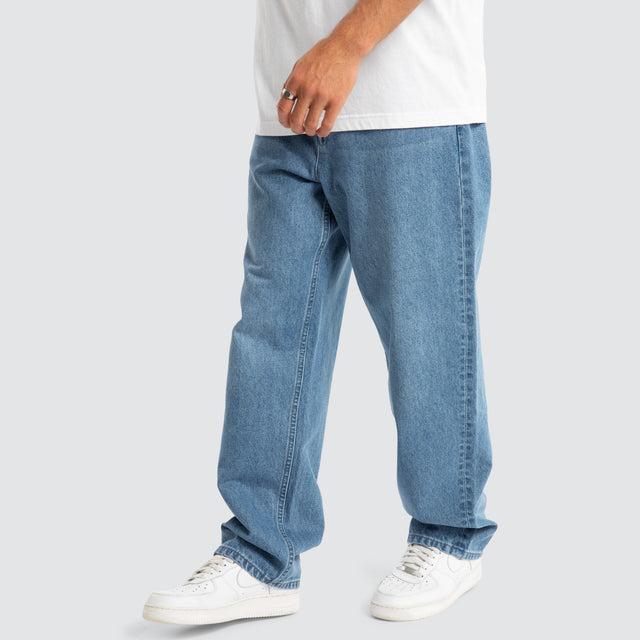 Model Wears Drive Athletic Baggy Jean Washed Blue Pants in Blue - Image 3