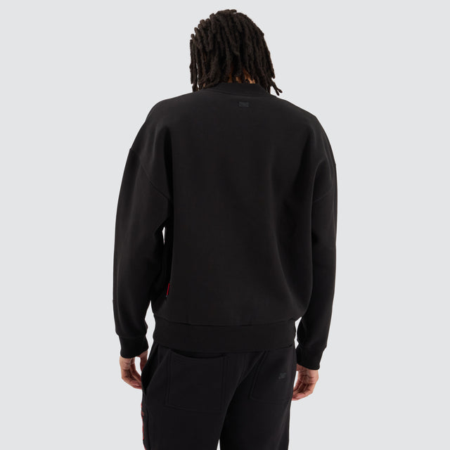 Model Wears Essendon Bombers AFL Box Fit Sweater Jet Black Jumpers in Black - Image 3