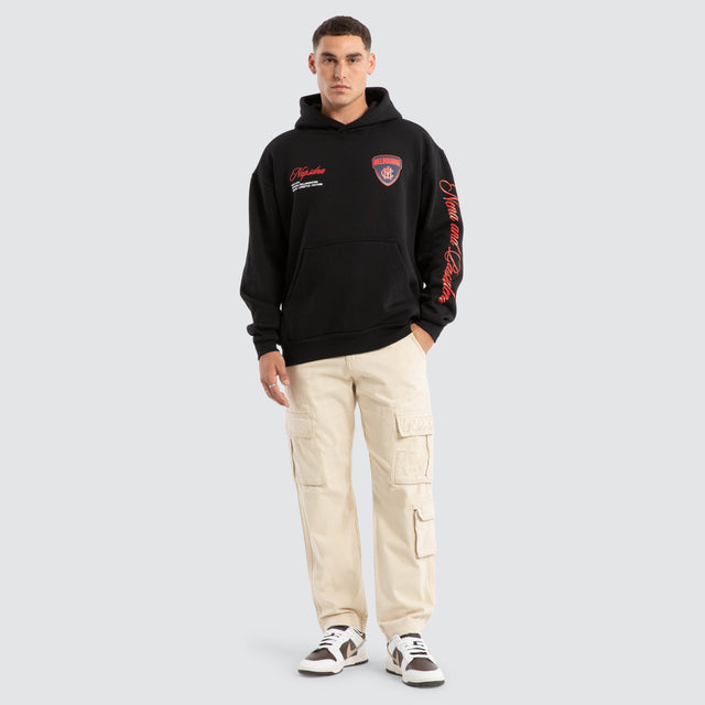 Model Wears Melbourne Demons AFL Season Hoodie Jet Black Hoodies in Black - Image 6