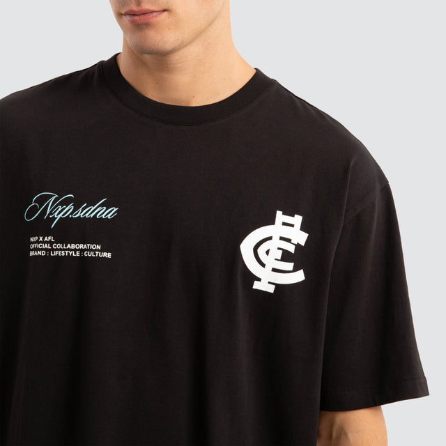 Model Wears Carlton Blues AFL Season Tee Jet Black T-Shirts in Black - Image 3