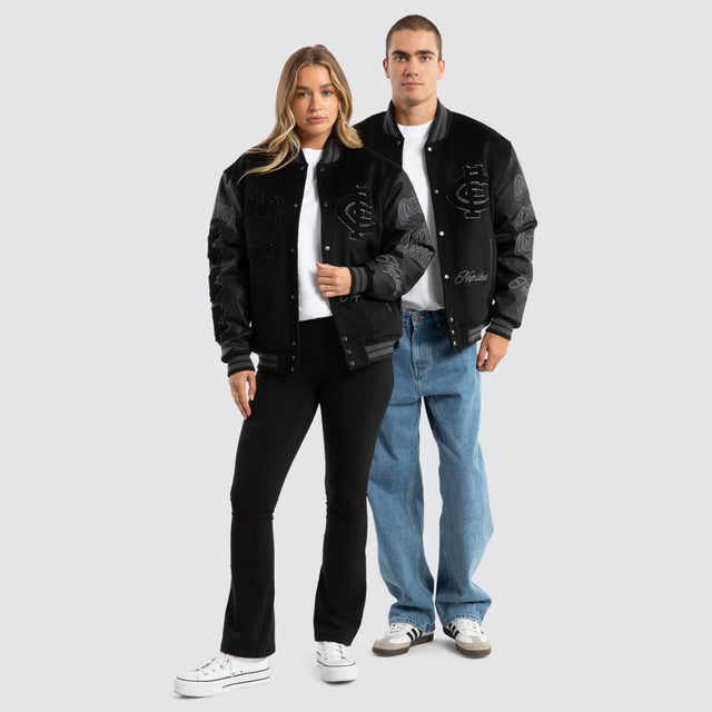 Model Wears Carlton Blues AFL Ace Varsity Jacket Jet Black Jackets in Black - Image 6