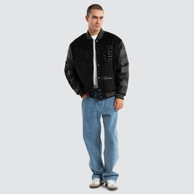 Model Wears Carlton Blues AFL Ace Varsity Jacket Jet Black Jackets in Black - Image 2