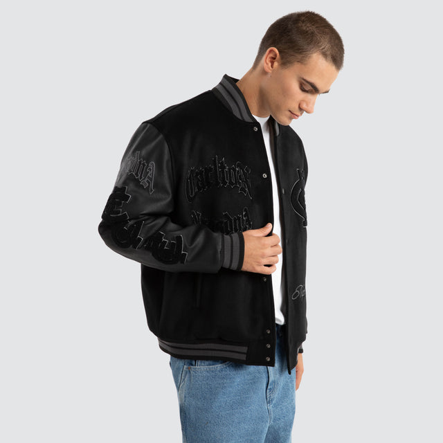 Model Wears Carlton Blues AFL Ace Varsity Jacket Jet Black Jackets in Black - Image 7