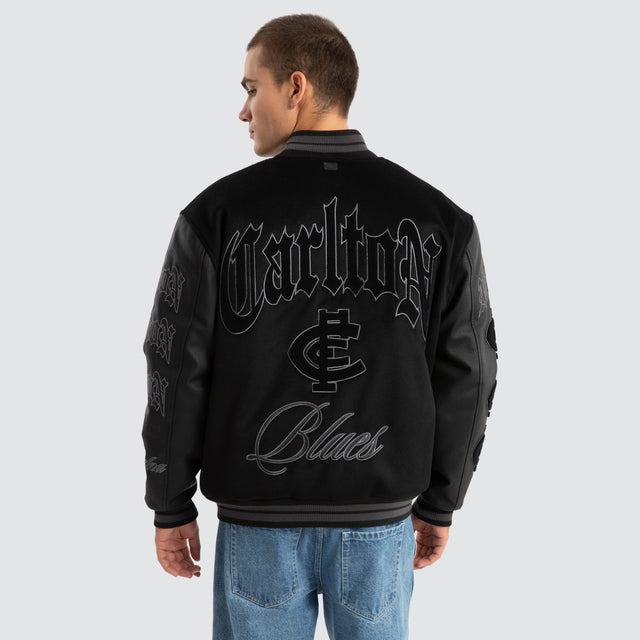 Model Wears Carlton Blues AFL Ace Varsity Jacket Jet Black Jackets in Black - Image 1