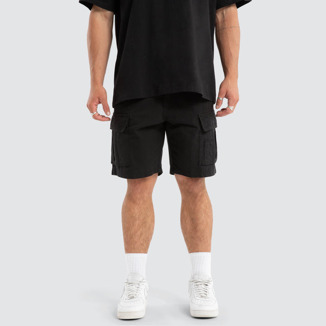 Model Wears Colby Cargo Shorts Black Shorts in Black - Image 1