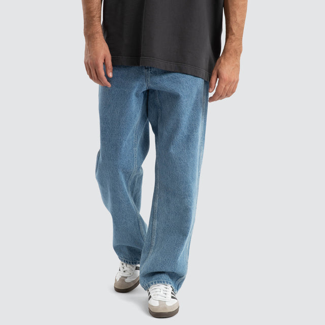 Model Wears Dillon Baggy Fit Jean Clean Blue Pants in Blue - Image 1