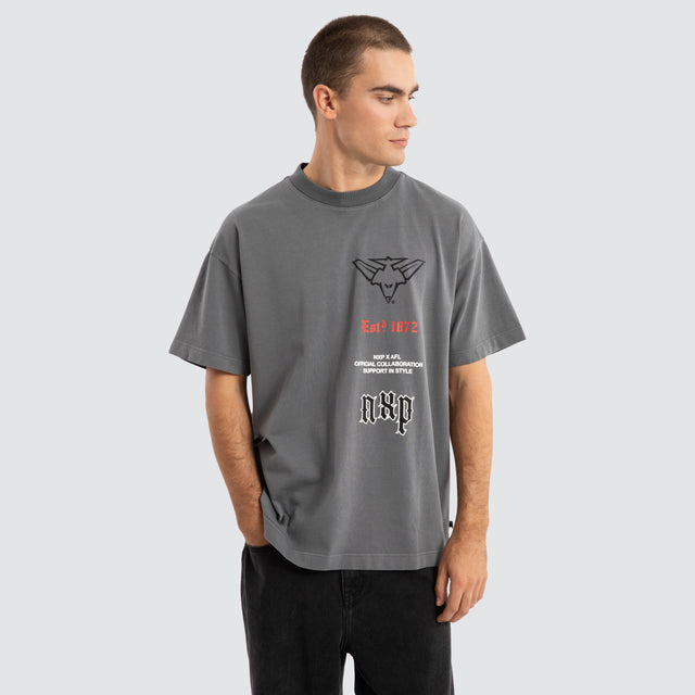 Model Wears Essendon Bombers AFL Stack Tee Pigment Charcoal T-Shirts in Grey - Image 5