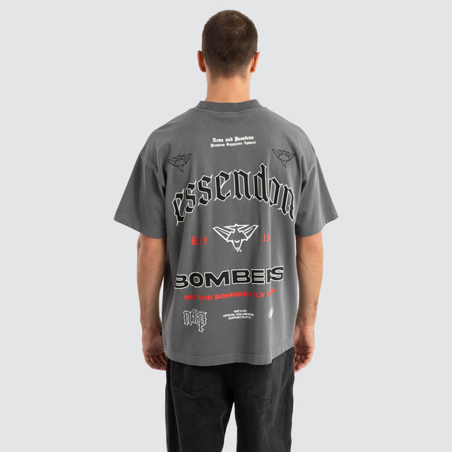 Model Wears Essendon Bombers AFL Stack Tee Pigment Charcoal T-Shirts in Grey - Image 1