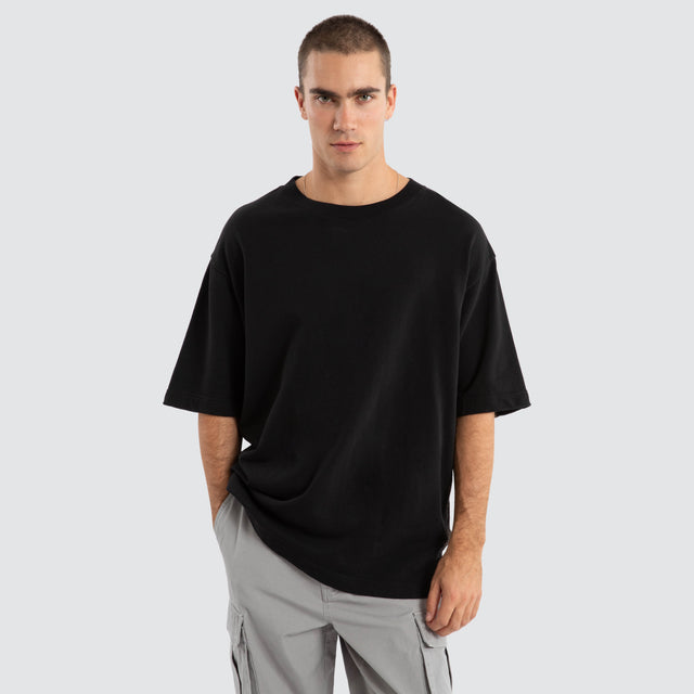 Model Wears Estevan Oversized Loopback Tee Jet Black T-Shirts in Black - Image 1
