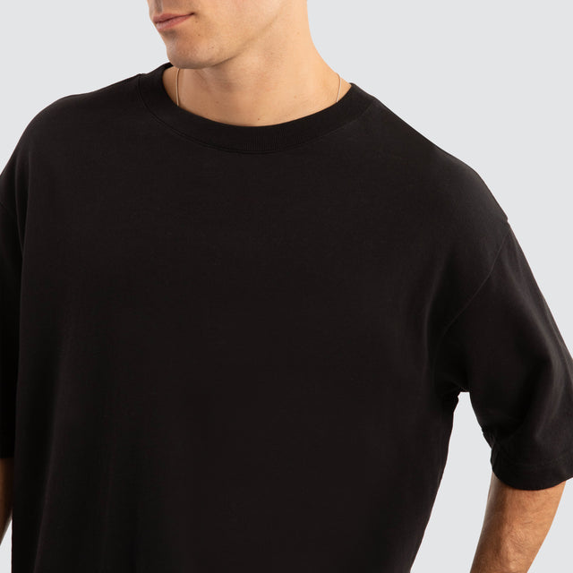 Model Wears Estevan Oversized Loopback Tee Jet Black T-Shirts in Black - Image 3