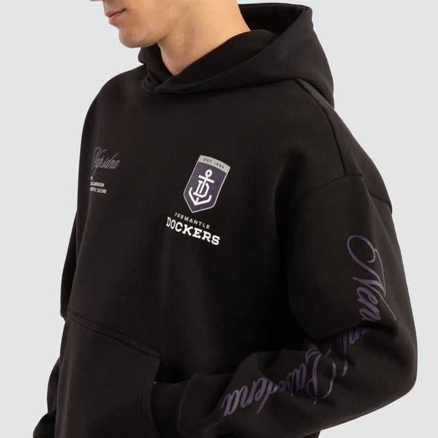 Model Wears Fremantle Dockers AFL Season Hoodie Jet Black Hoodies in Black - Image 4