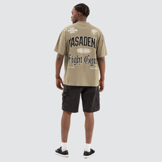 Model Wears Rattle Raptor Tee Khaki Green T-Shirts in Green - Image 4