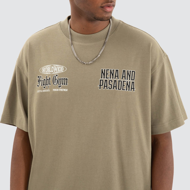 Model Wears Rattle Raptor Tee Khaki Green T-Shirts in Green - Image 5