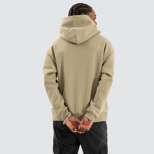 Model Wears Warrior Relaxed Hoodie Khaki Green Hoodies in Green - Image 4