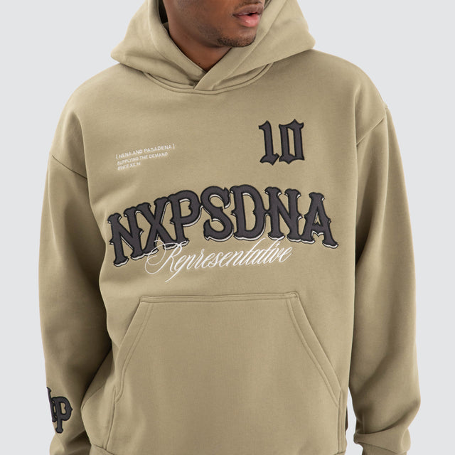 Model Wears Warrior Relaxed Hoodie Khaki Green Hoodies in Green - Image 5