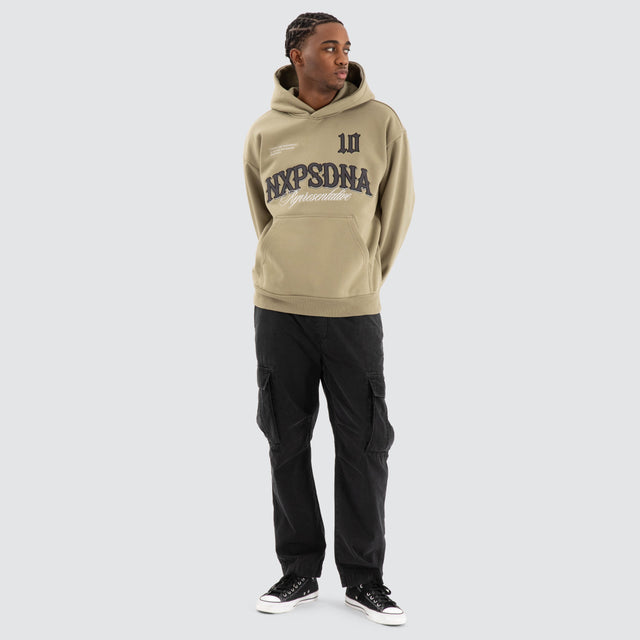 Model Wears Warrior Relaxed Hoodie Khaki Green Hoodies in Green - Image 2
