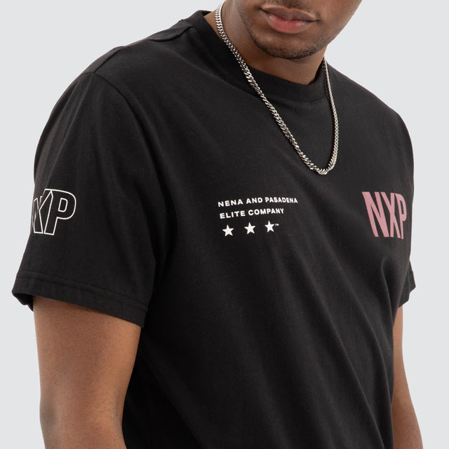 Model Wears Harbor Dual Curved Tee Jet Black/Vintage Rose T-Shirts in Black - Image 5