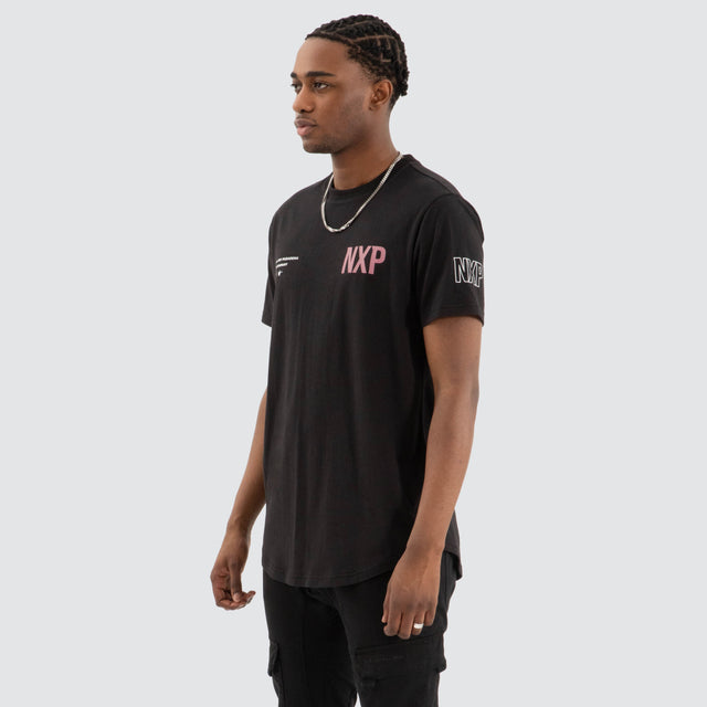 Model Wears Harbor Dual Curved Tee Jet Black/Vintage Rose T-Shirts in Black - Image 3