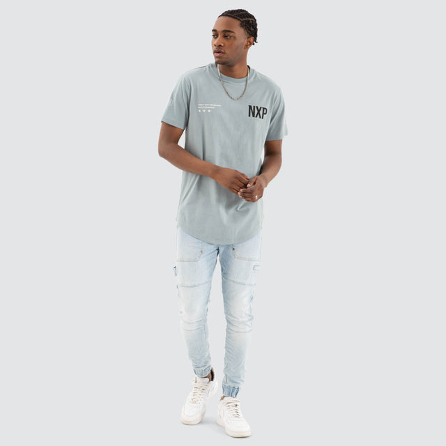 Model Wears Harbor Dual Curved Tee Lead Blue/Black T-Shirts in Blue - Image 3