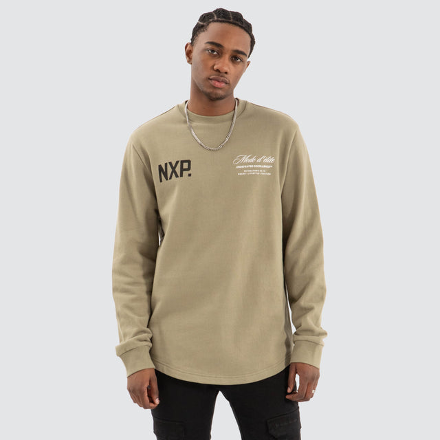 Model Wears Mate Dual Curved Sweater Khaki Green Jumpers in Green - Image 1