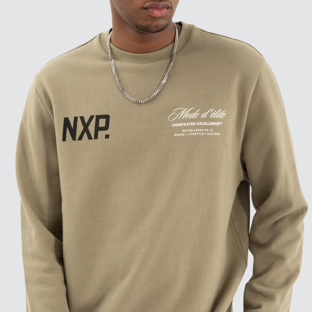 Model Wears Mate Dual Curved Sweater Khaki Green Jumpers in Green - Image 5