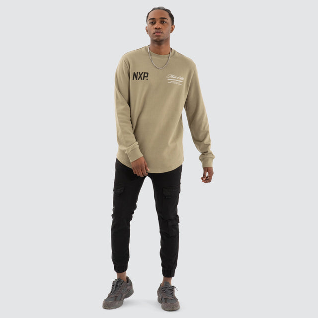 Model Wears Mate Dual Curved Sweater Khaki Green Jumpers in Green - Image 2