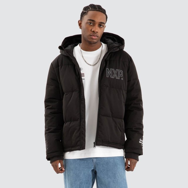 Model Wears Burden Hooded Puffer Jet black Jackets in Black - Image 1
