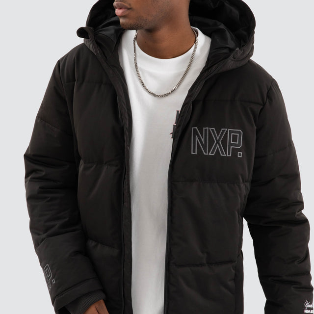 Model Wears Burden Hooded Puffer Jet black Jackets in Black - Image 5