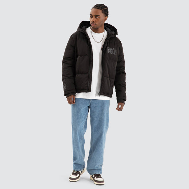 Model Wears Burden Hooded Puffer Jet black Jackets in Black - Image 2