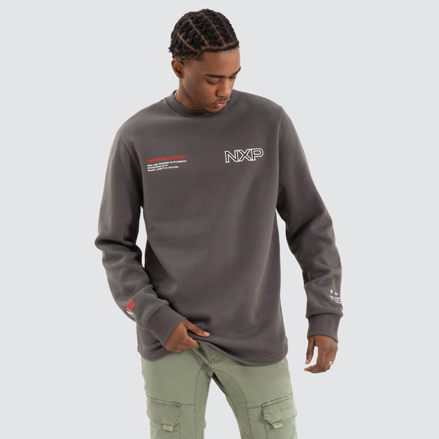 Model Wears Thunder Dual Curved Sweater Asphalt Grey Jumpers in Grey - Image 2