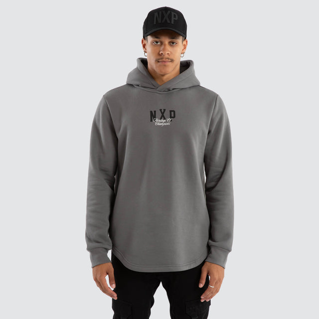Model Wears Crossover Dual Curved Hoodie Charcoal Hoodies in Grey - Image 2