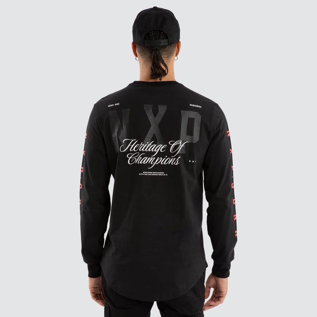 Model wears Final Dual Curved Longsleeve Tee Jet Black Longsleeve T-Shirts in Black - Image 1