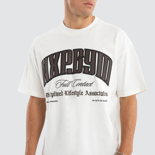 Model wears Citizens Raptor Tee Natural White T-Shirts in White - Image 6