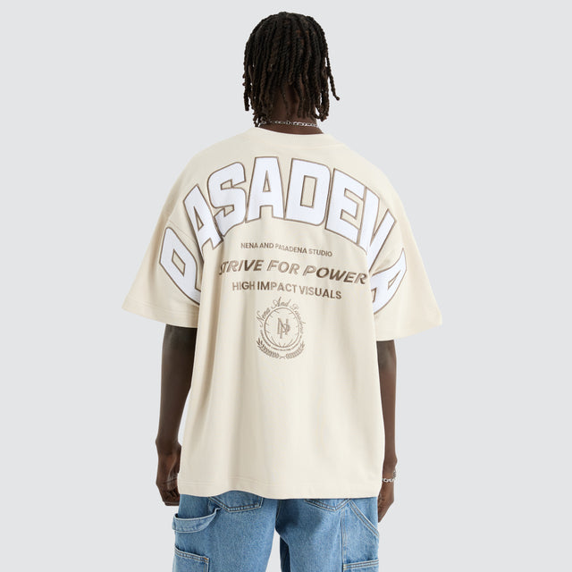 Model Wears Armour Loopback Raptor Tee Moonbeam T-Shirts in Off-White - Image 1