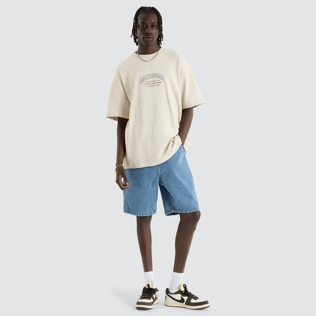 Model Wears Armour Loopback Raptor Tee Moonbeam T-Shirts in Off-White - Image 5