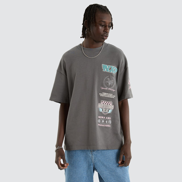 Model Wears Remain Loopback Raptor Tee Charcoal T-Shirts in Grey - Image 1