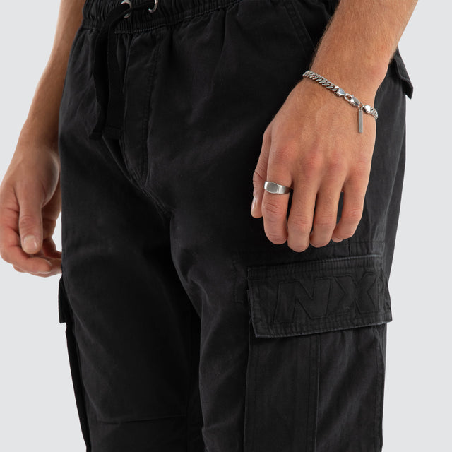 Model Wears League Cargo Pant Black Pants in Black - Image 4