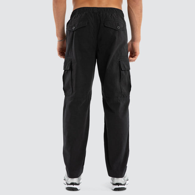 Model Wears League Cargo Pant Black Pants in Black - Image 5