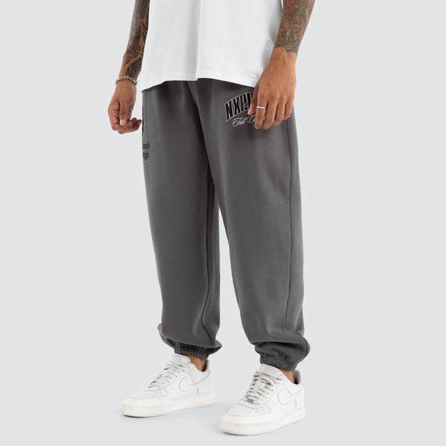 Model Wears Wonder Baggy Trackpant Charcoal Trackpants in Grey - Image 1